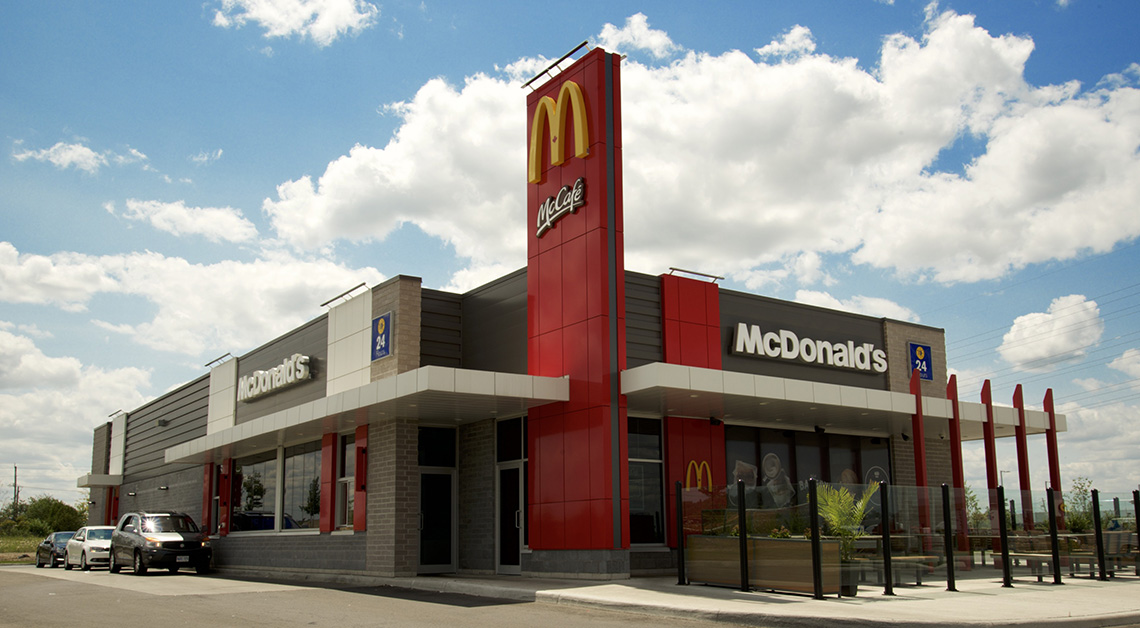 McDonald's restaurant in North America with a modern facade using a combination of Aluminum Composite Panels (ACM panels), metal siding panels, and Longboard Aluminum Siding cladding materials