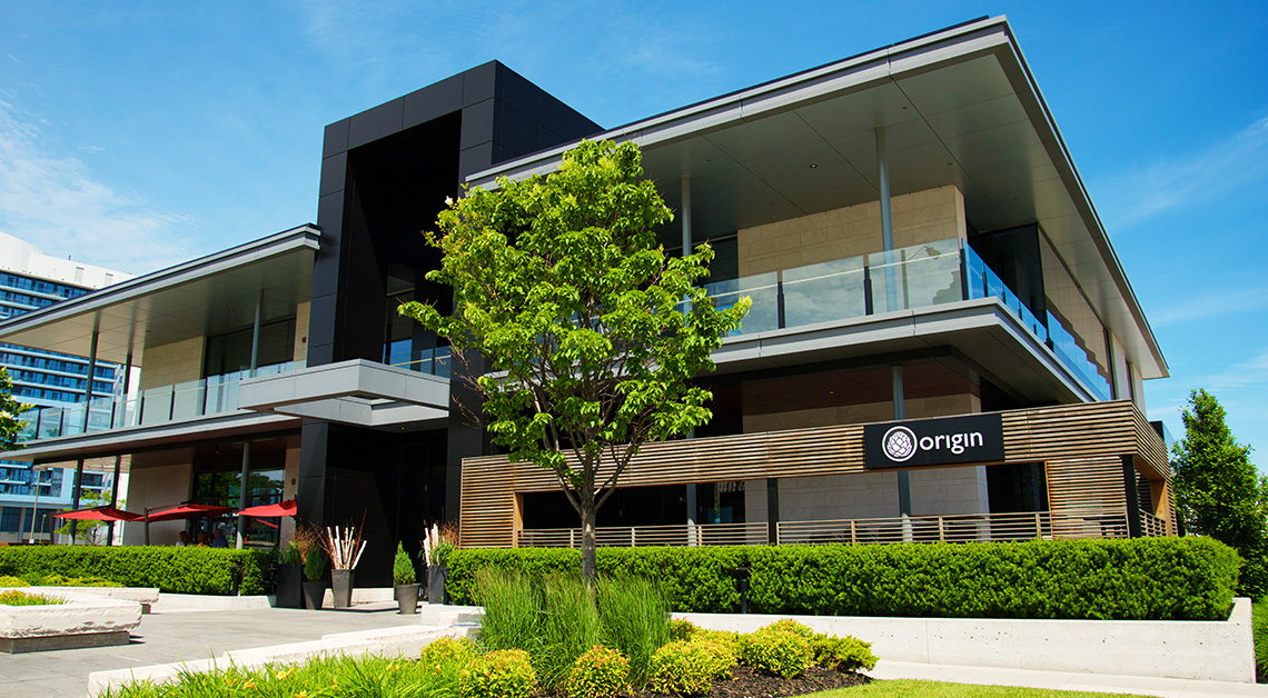 Exterior view of Origin restaurant in Toronto with a modern design, featuring cladding made of Aluminum Composite Panels (ACM panels)