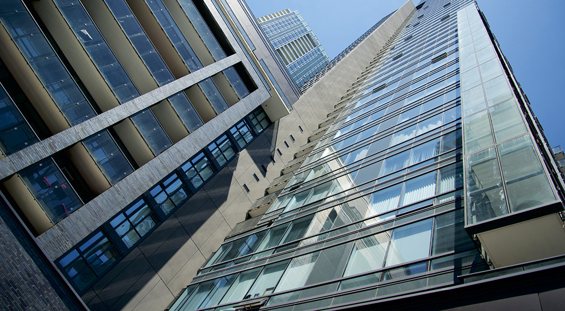 Facade of 295 Adelaide St W, a residential and commercial building showcasing a diverse range of cladding materials such as louvres cladding, aluminum plate, and cement board siding